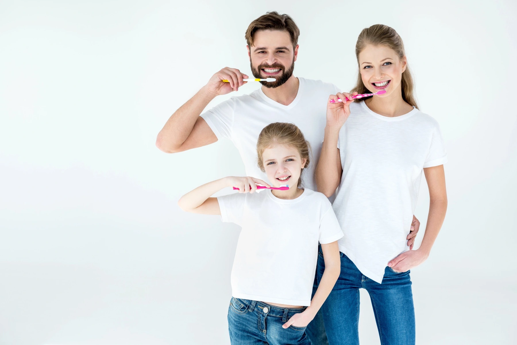 Illustrative family brushing their teeth at home.